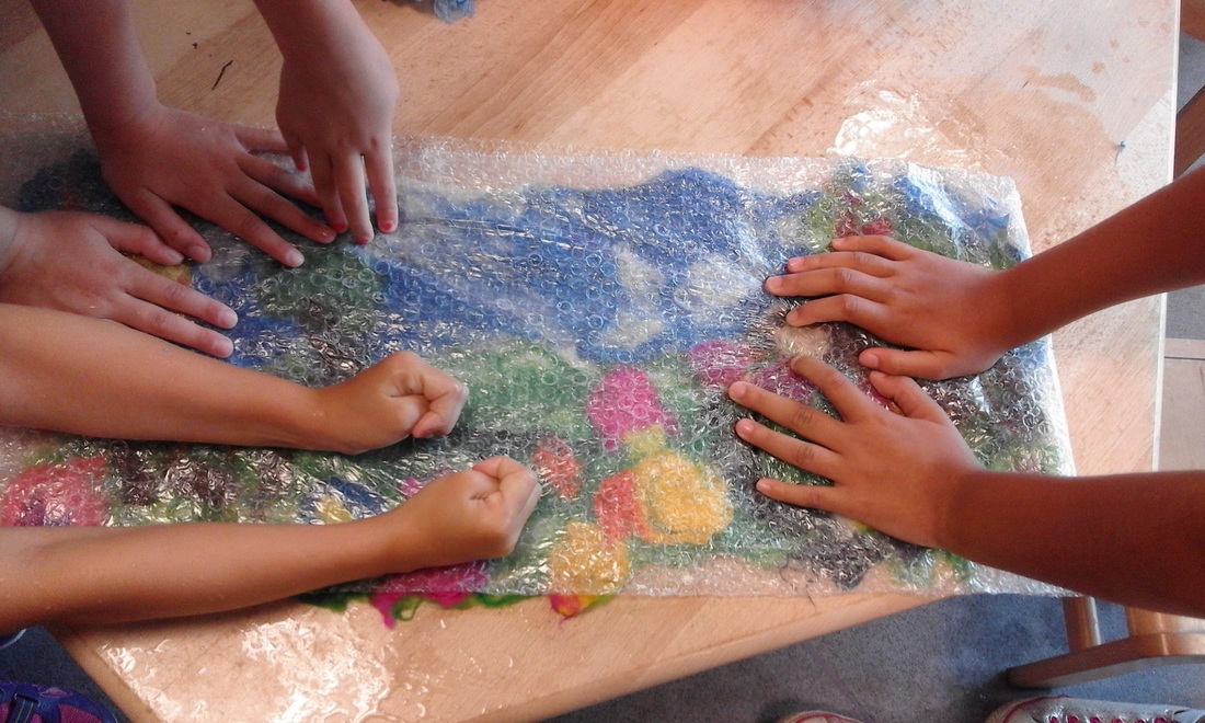 Children creating mosaic art work