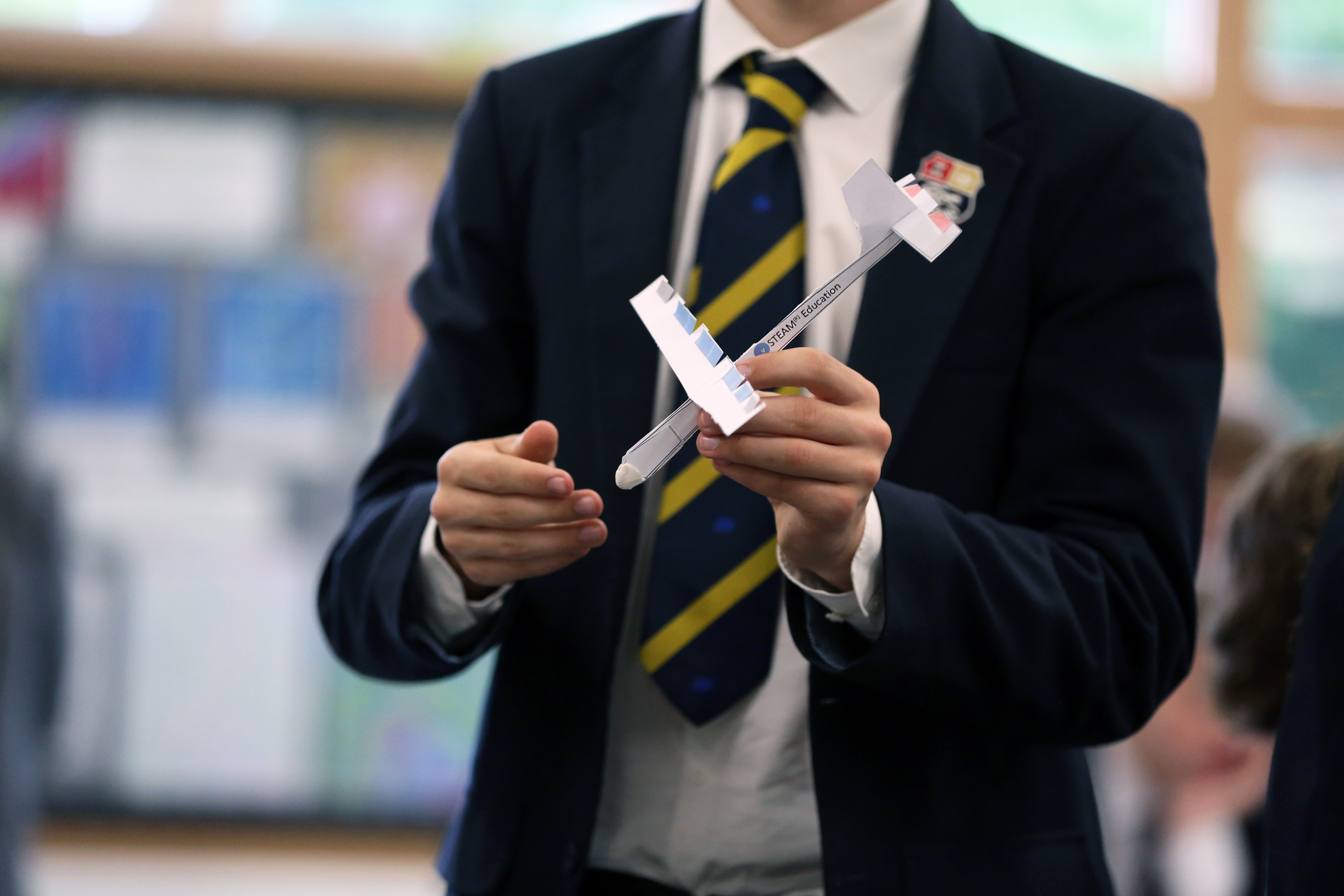 Student Holding Aircraft Glider