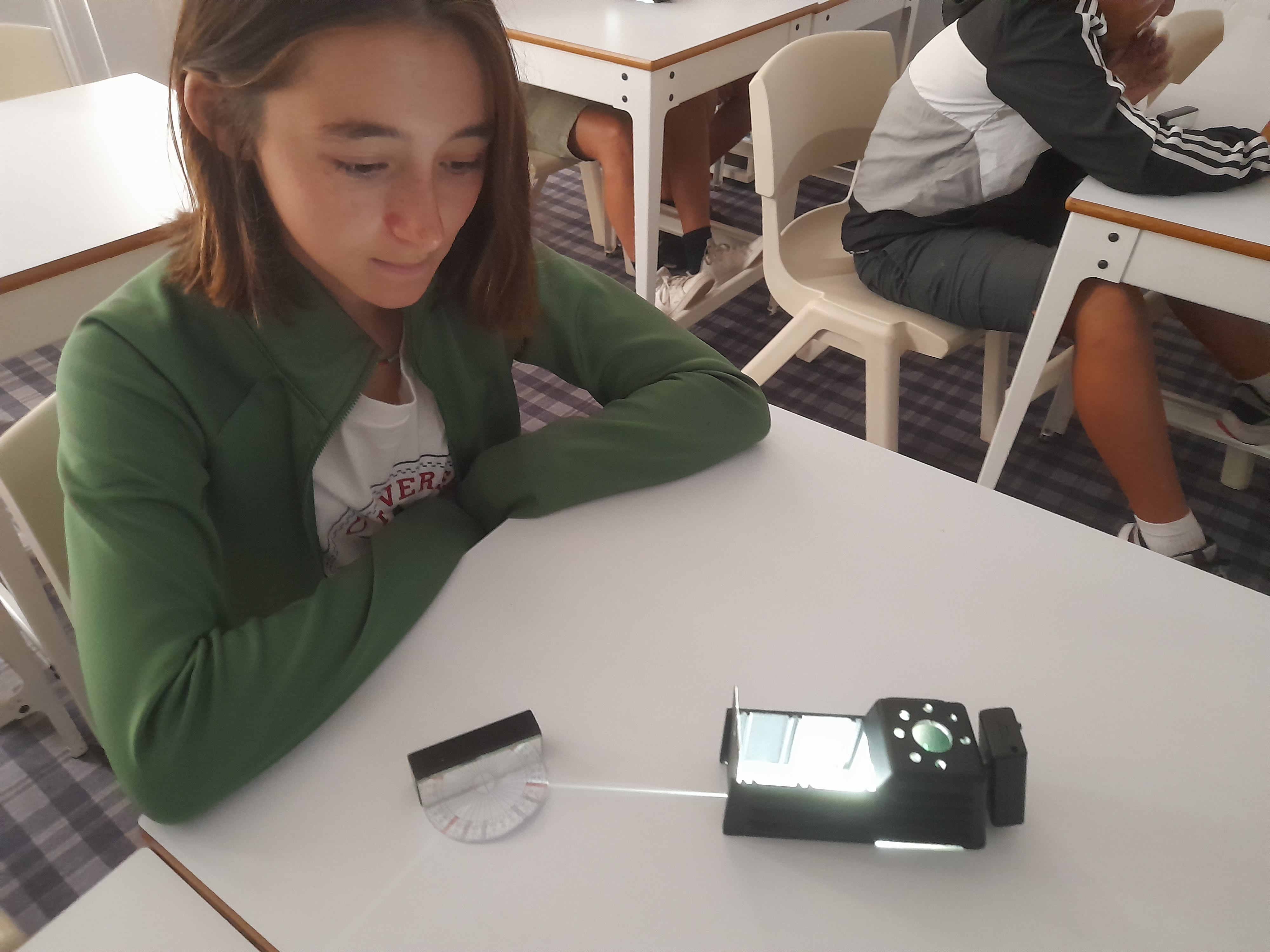 Student Observing Reflection with Light Ray Box