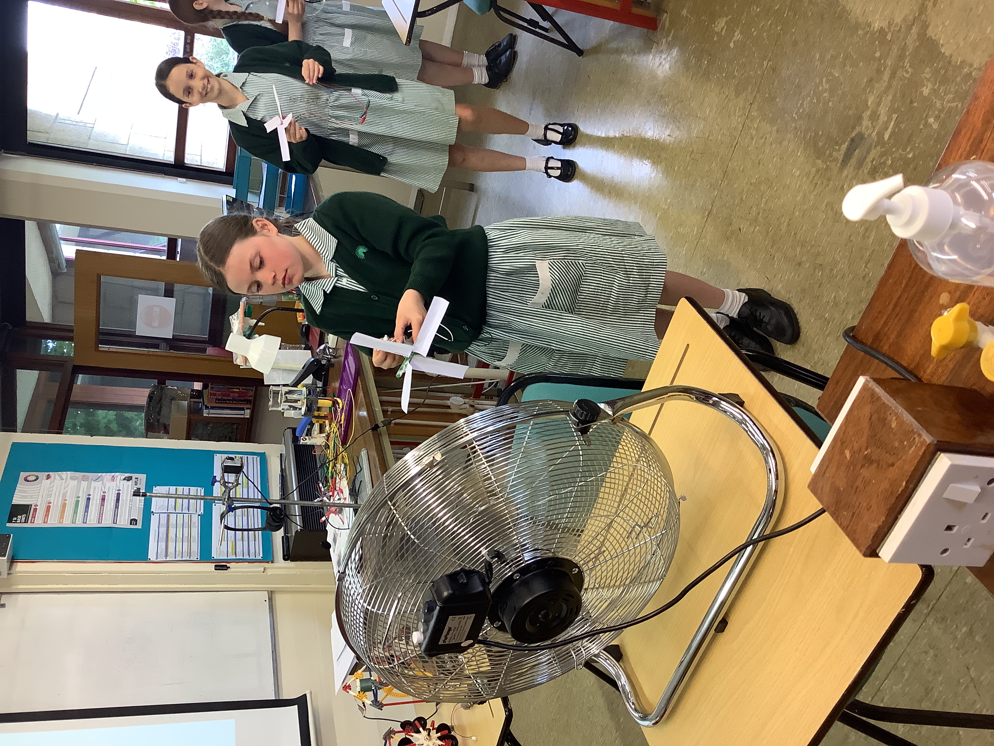Student Holding Craft Windmill to Fan