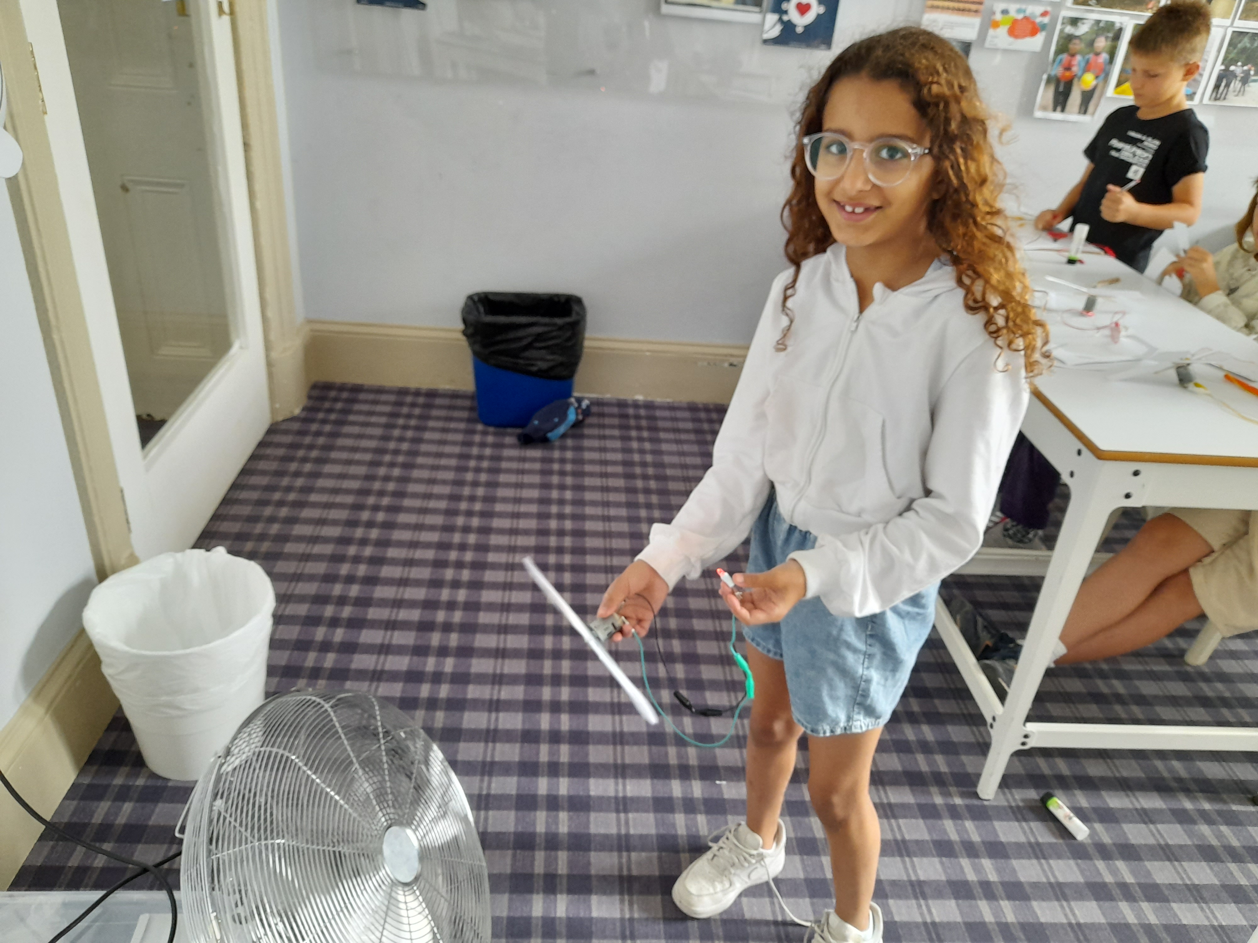 Child Holding Windmill to the Fan