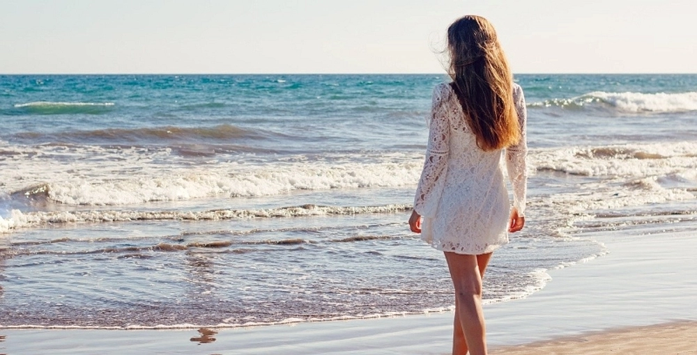 Woman walking on beach