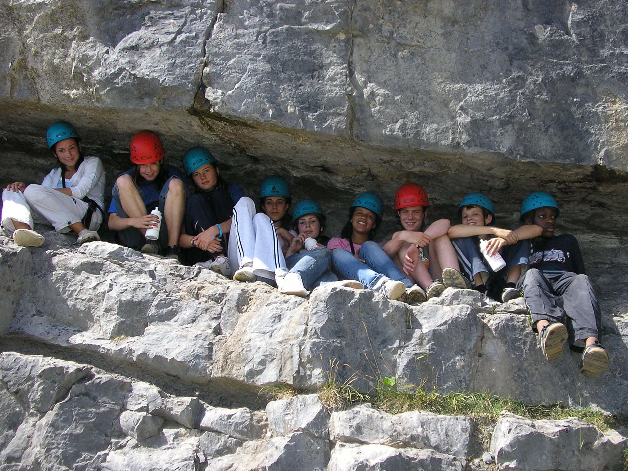 Children resting on climbed rocks