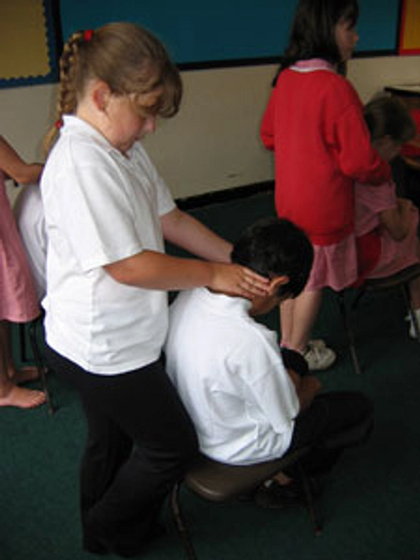 Children practising massage techniques