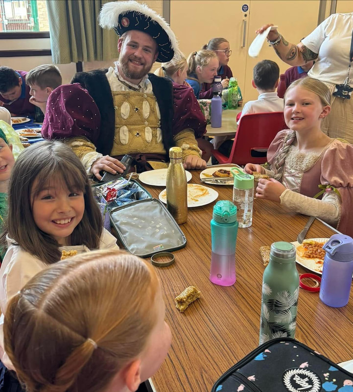 King Henry eating school lunch with children