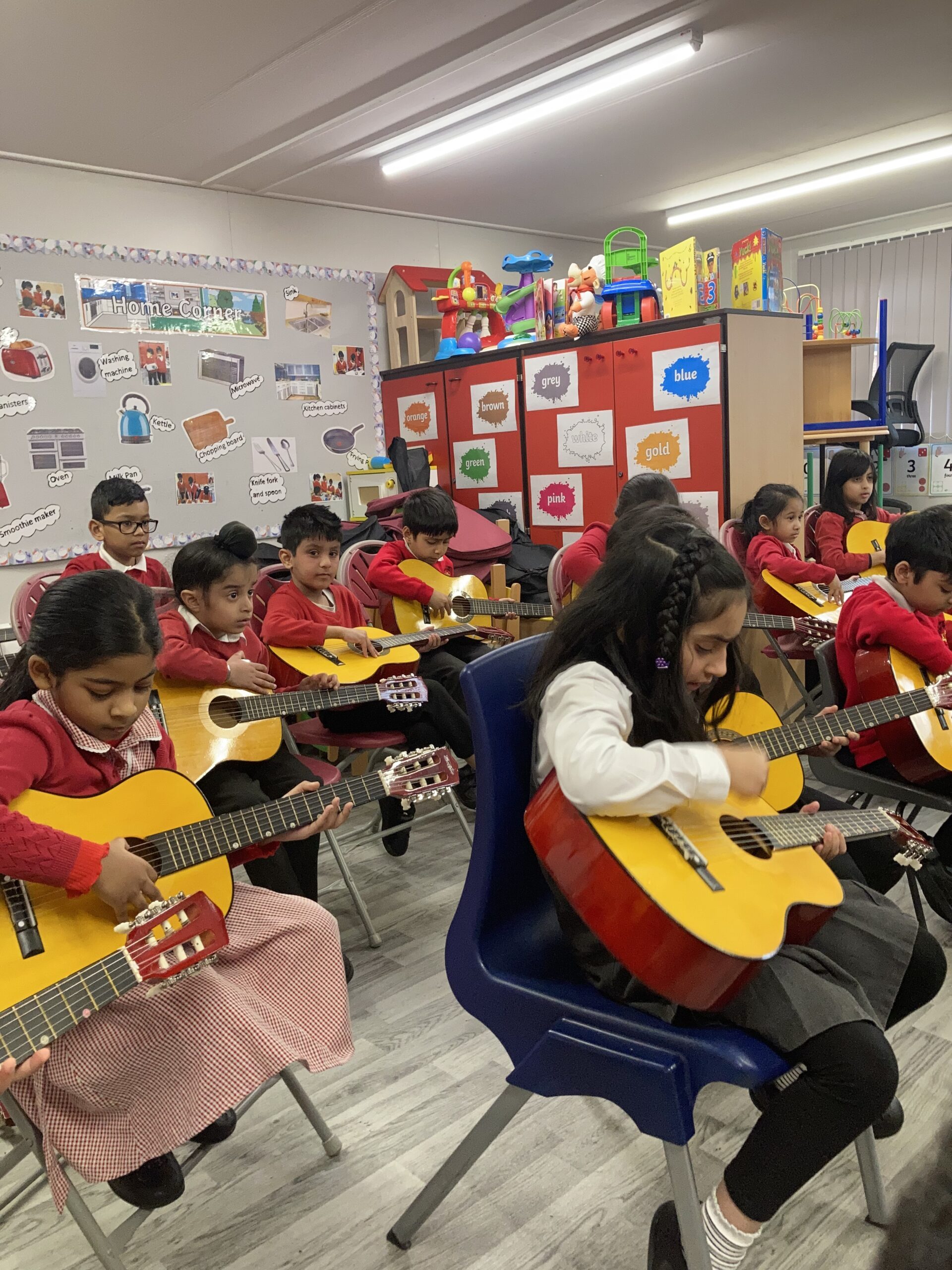 Girls playing guitar in school