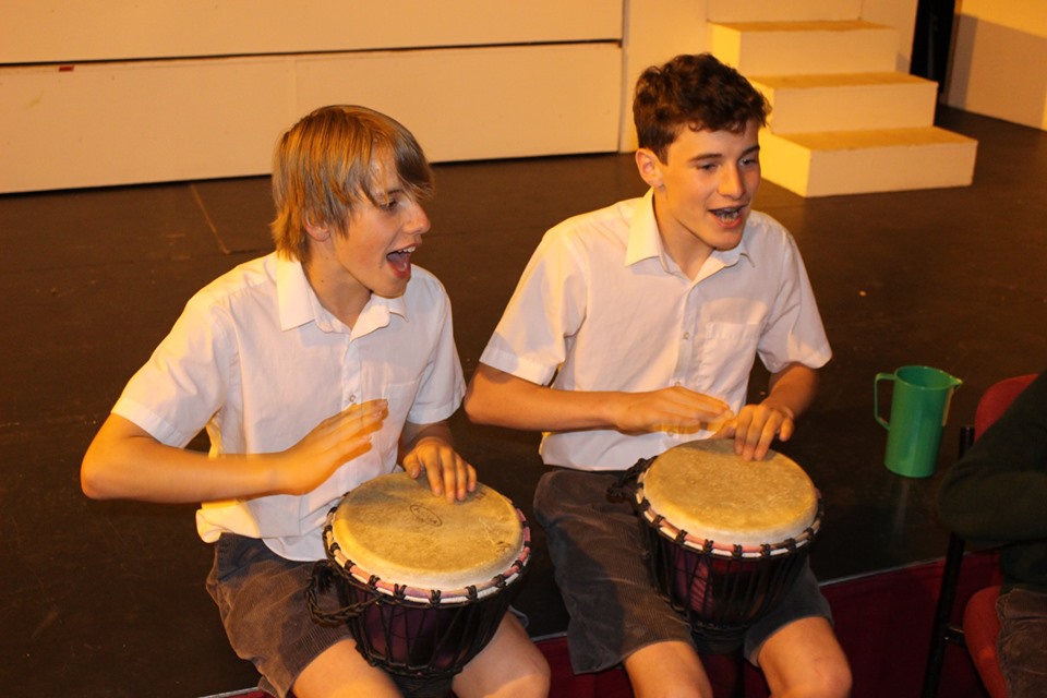 Boys drumming and singing