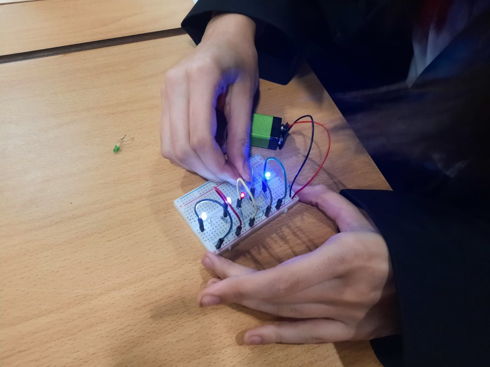 Student Building LED Circuit on Breadboard